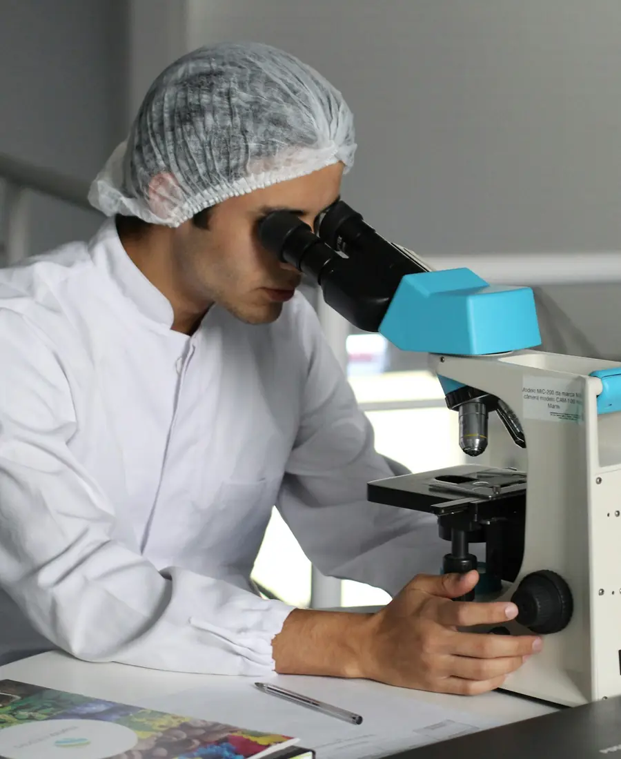 Specialist working with a microscope in a laboratory