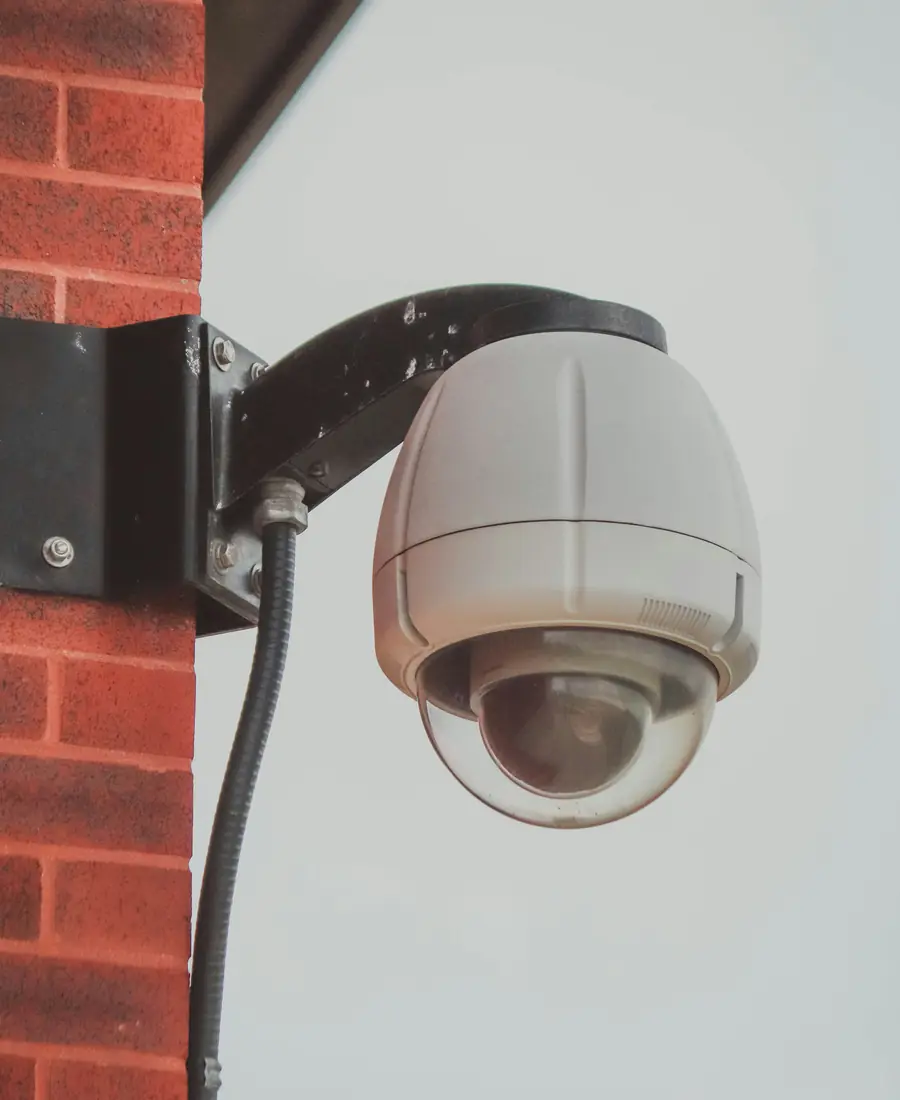 Dome CCTV camera on a brick wall