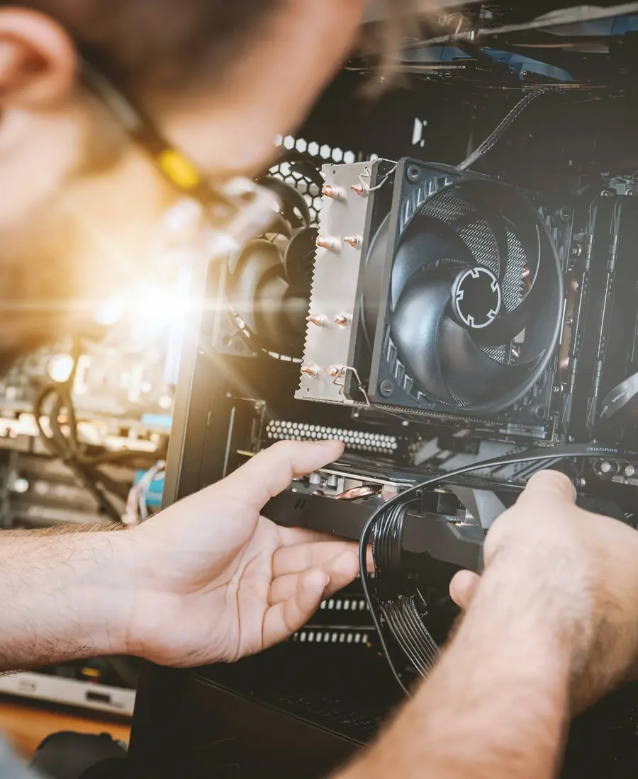 IT technician installing a component in a computer system