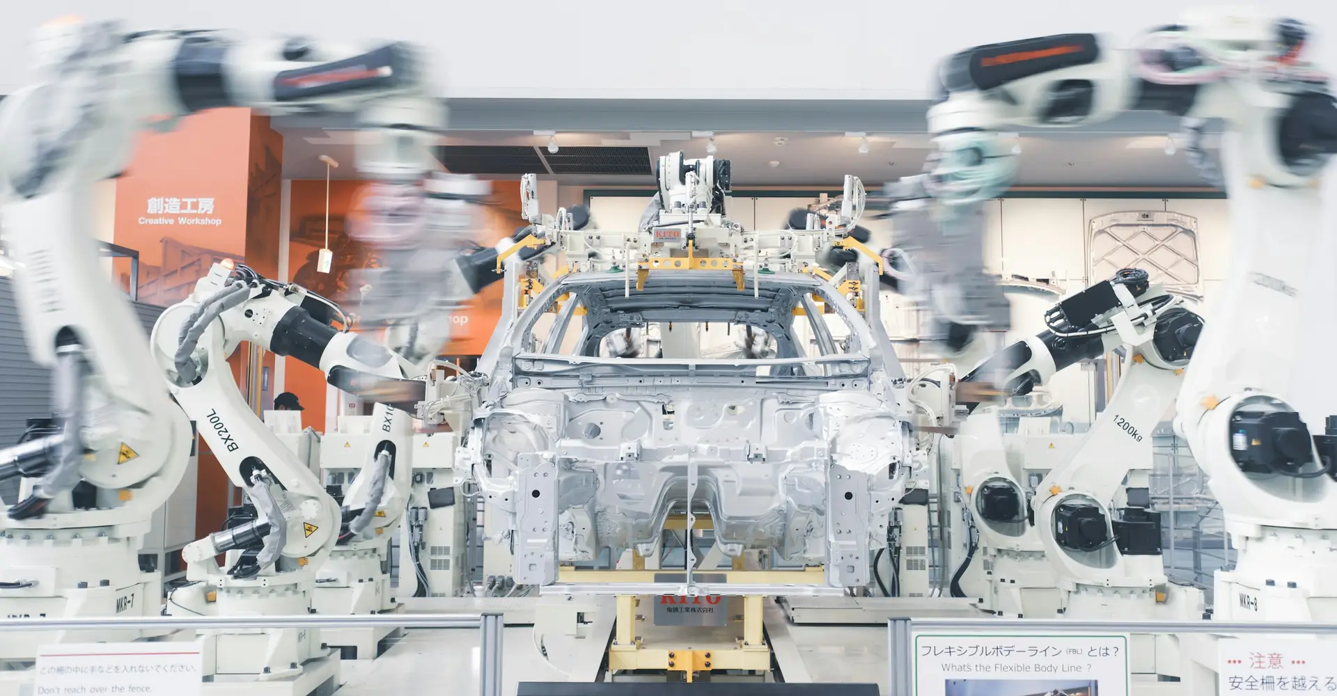 Robotic arms assembling car chassis on a production line