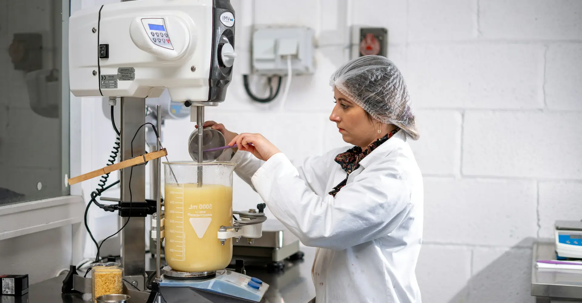 Laboratory technician in a white coat in a cosmetics laboratory