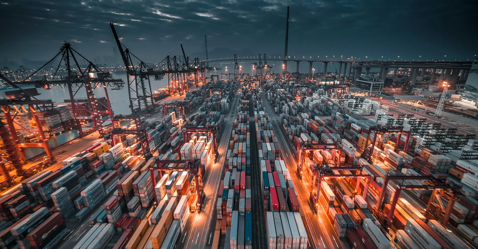 Port with stacked containers and cranes