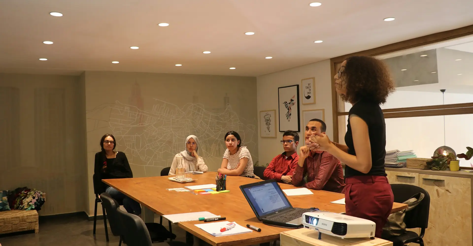 A trainer leading a session for a group in a training room