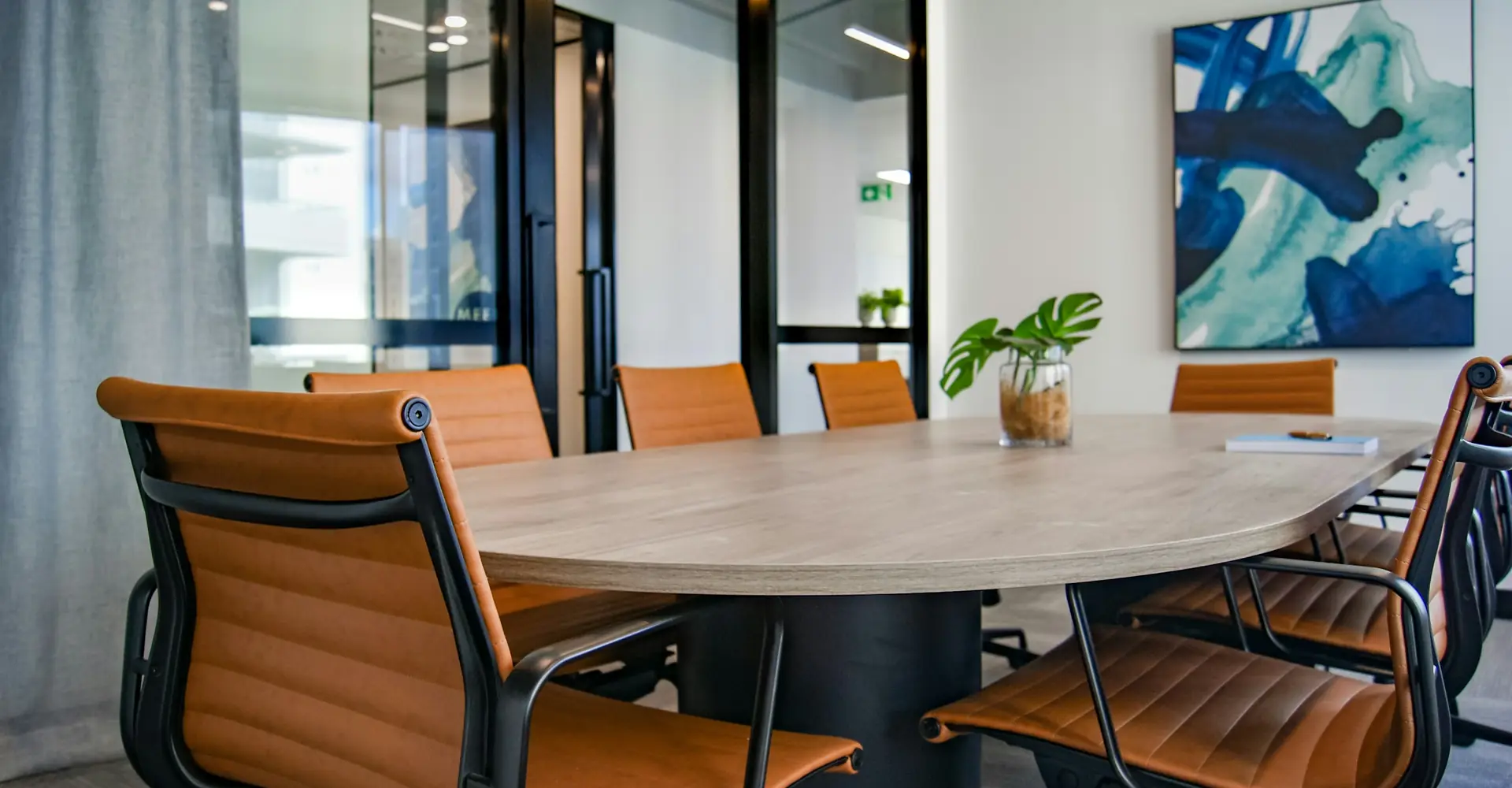 Meeting room with an oval table and leather chairs